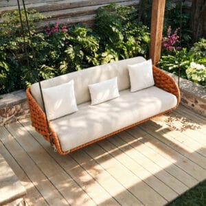Refined outdoor swing with cushion featuring a handwoven all-weather rope frame.