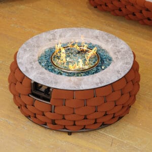 Elegant round outdoor propane fire pit features hand-woven rattan and marble-look top.