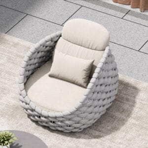 Relaxed outdoor lounging on the Cocaro Outdoor Lounge Chair featuring a plush cushion and swivel design.