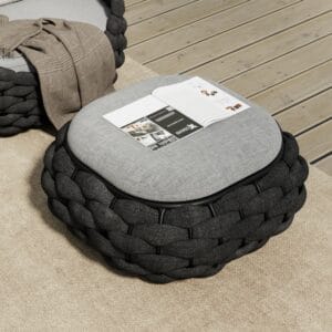 This stylish outdoor storage ottoman features a cushioned lift-up seat and curved sides.