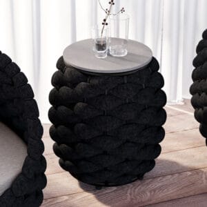 Cocaro outdoor side table with storage features a handwoven waterproof rope design and durable slate top.