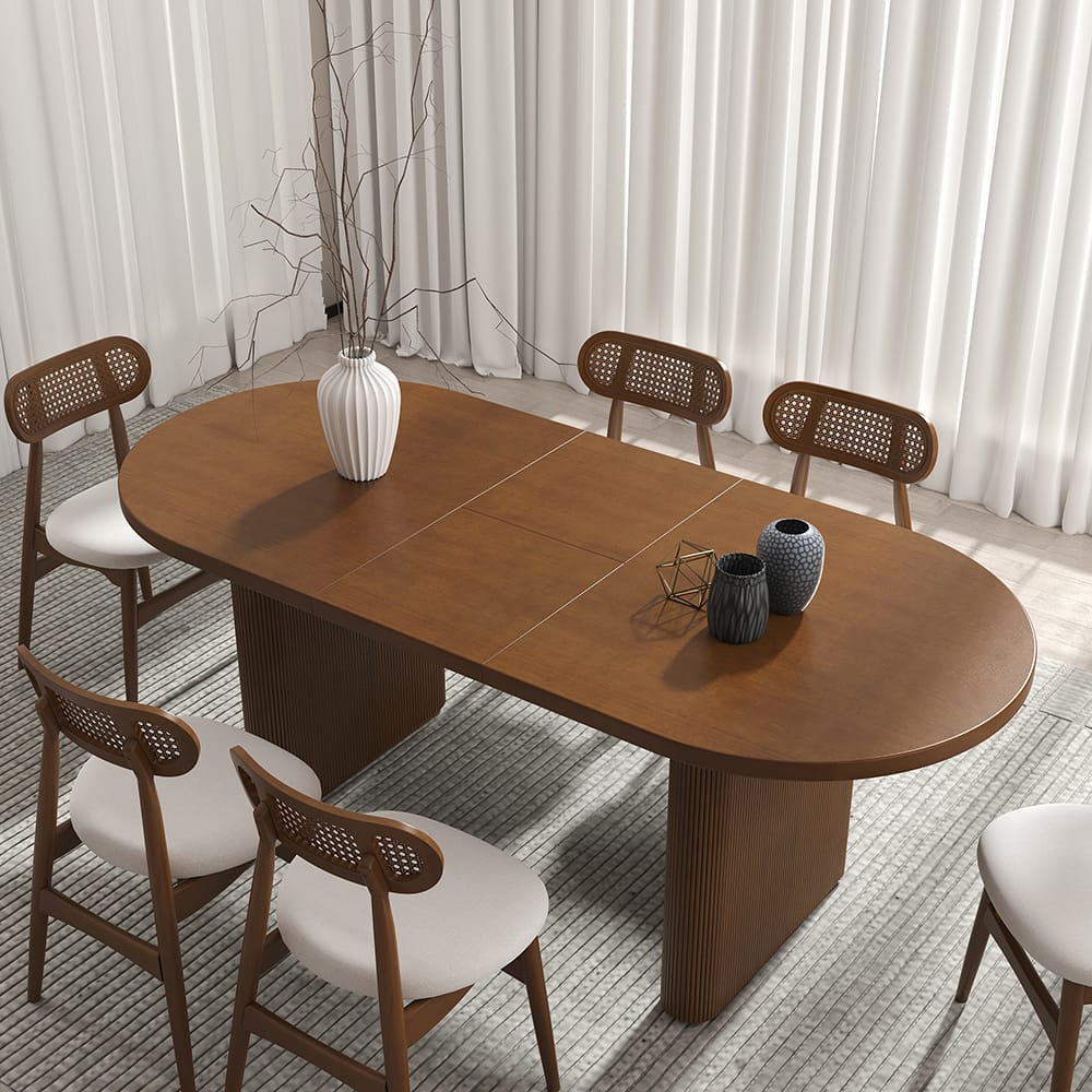 Stylish Japandi oval extendable dining table made from solid wood in natural walnut finish.