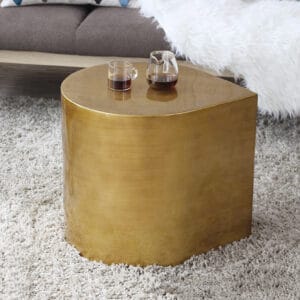 Stand-alone modern metal side table features a polished cast brass design with etched details.