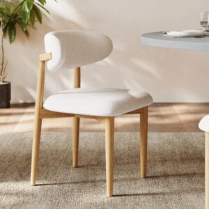 Ergonomic curved back modern dining chair in boucle, linen, or PU leather upholstery.