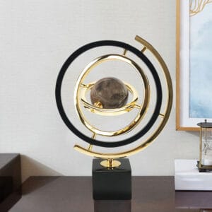 Sleek black and gold metal globe sculpture decor with abstract design on rectangular base.