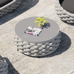 Stylish round outdoor coffee table gray with a sintered stone top and woven aluminum rope base.
