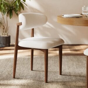 Modern walnut dining chair featuring ergonomic curved back and stable rubberwood frame.