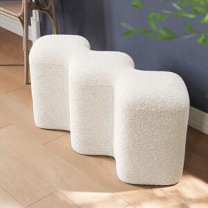 Modern white entryway bench upholstered in soft boucle with a geometric design.