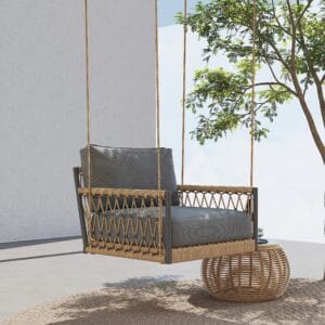 Boho-inspired outdoor swing sofa with khaki rattan frame and plush gray cushions.