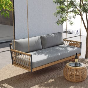 Boho-style outdoor swing sofa made from hand-woven rope and weather-resistant aluminum frame.