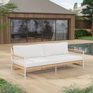 Enjoying summer days on a rattan outdoor sofa with cushion, featuring nautical rope design.