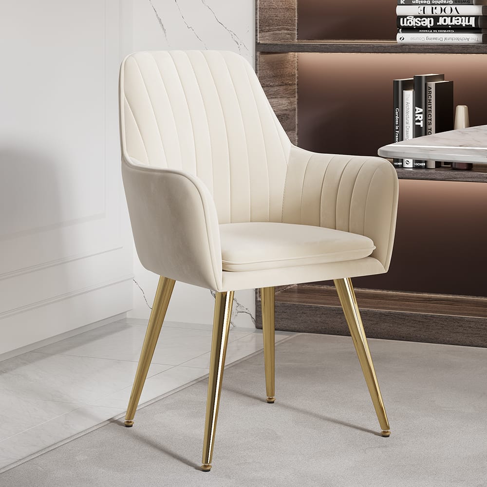 Elegant beige velvet dining chairs featuring a padded seat and gold metal legs.