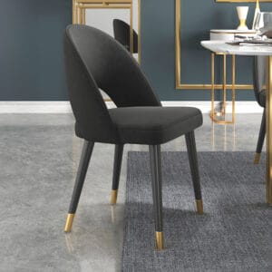 Curved high-back black velvet dining chairs with elegant upholstery and sturdy ash wood legs.