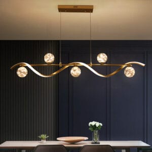Minimalist gold linear kitchen lighting featuring a sleek LED strip and glass globes.