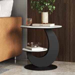 Moon-shaped sintered stone side table with marble-pattern top and soft gray metal base.