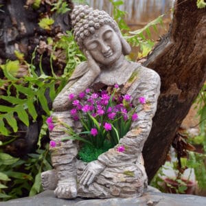 A tranquil sleeping buddha garden sculpture made from magnesium oxide, perfect for zen decor.