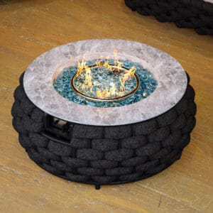 Elegant round outdoor propane fire pit featuring hand-woven rattan and a marble-look top.