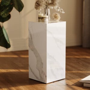 Luxurious sintered stone pedestal table featuring elegant chamfered edges and natural veining.